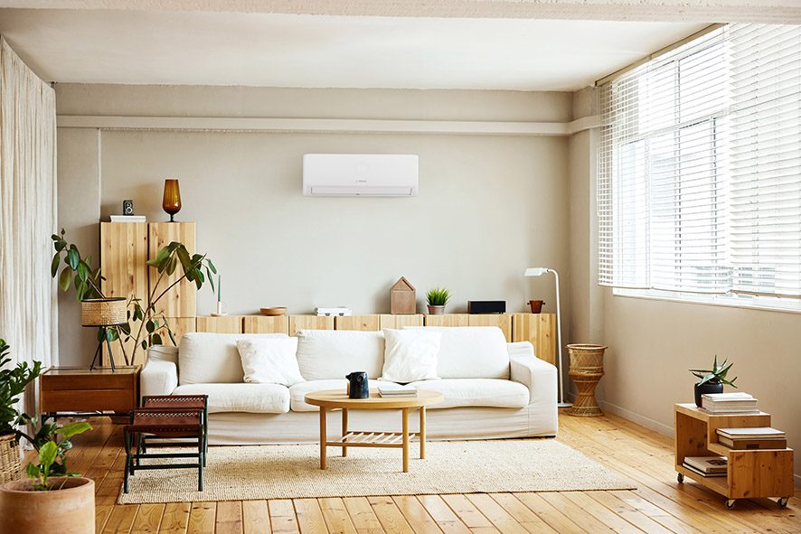 Discreet wall-mounted air conditioning unit in a bright living room
